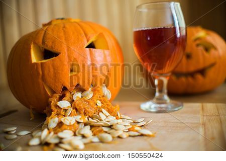 Pumpkin Puking With Pumpkin Seeds On Wood Table, Glass Of Wine