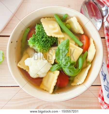 Rustic soup with fresh vegetables and ravioli