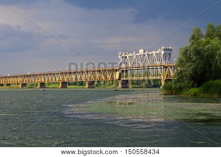 Bridge across river Dnieper in Kremenchug and storm clouds in sky