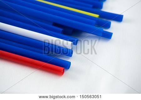 Multicolored tubes for water rolls of blue yellow and red color on a white background