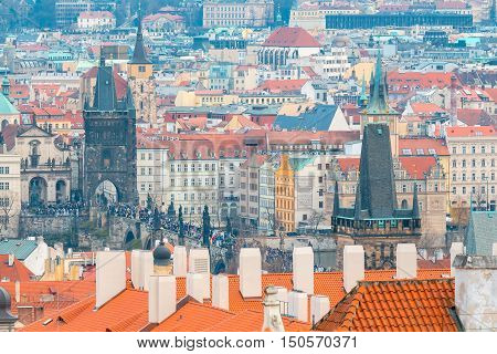 Aerial view of the historic center of Prague with towers, spiers and red-tiled roofs.