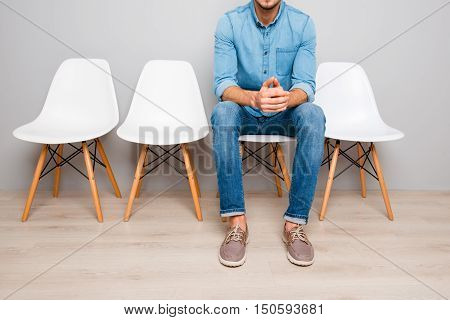 Close Up Of Man In Jeans Waiting For Smth While Sitting On Chair