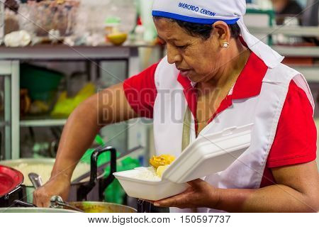 Banos De Agua Santa Ecuador - 23 2016: Unidentified Chef Woman From Banos De Agua Santa Is Preparing A Dish In Banos De Agua Santa On 23 2016