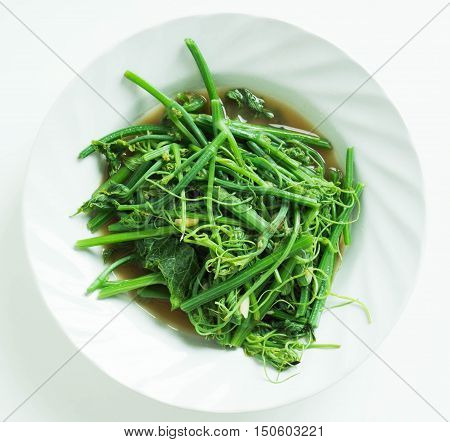 Fried bitter gourd leaf with oyster sauce ,This is a local Thai