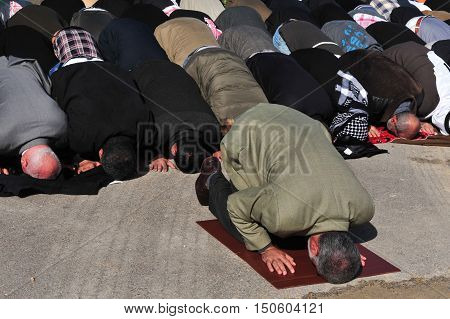 Men during a mass muslim prayer session