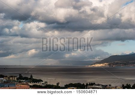 The Messina Strait seen from Sicily Italy. Beautiful moving clouds over vast spaces.