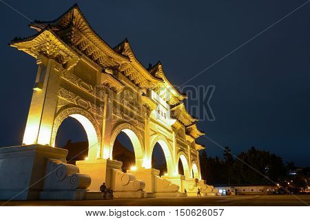 TAIPEI, TAIWAN - SEPTEMBER 8, 2016: Night lights shine on the gated entrance to Liberty Square in Taipei. The Chinese text says: 