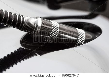 Close-up of electric guitar cable jack pluged