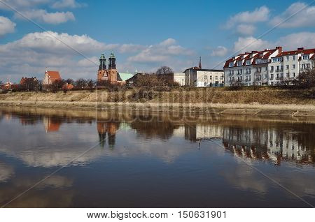 Urban landscape with river Warta the cathedral towers and residential houses in Poznan