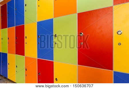 Wooden multi color painted school lockers in hallway