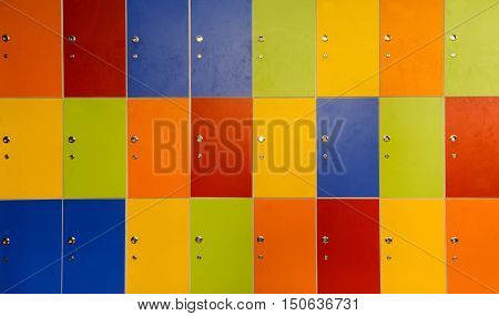 Wooden multi color painted school lockers in hallway