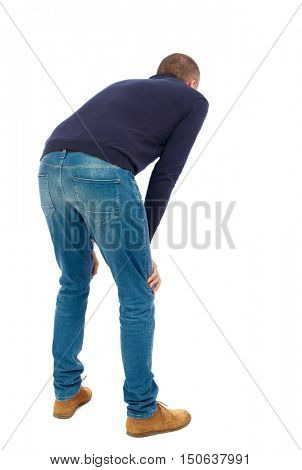 Back view of a man who rests in his hands leaning. Standing young guy. Rear view people collection.  backside view of person.  Isolated over white background.  Man in warm jacket is resting wearily.