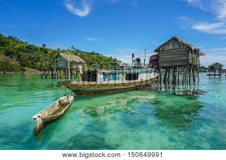 The traditional sea gypsy water village with the unique boat in Bodgaya Island at Semporna,Sabah,Borneo,Malaysia.One of the main attraction of Semporna with clear blue water,sand & palm trees.