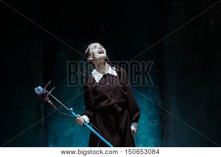 Portrait of a young girl with drop counter as a vampire woman against school board . The image in the style of Halloween