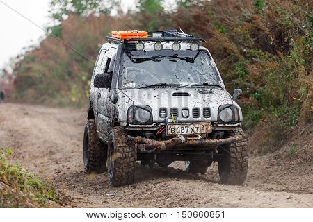 KRASNORECHENSKOYE RUSSIA - SEPTEMBER 24 2016: Small japaneese SUV Suzuki Jimny with off-road tuning on dirt road