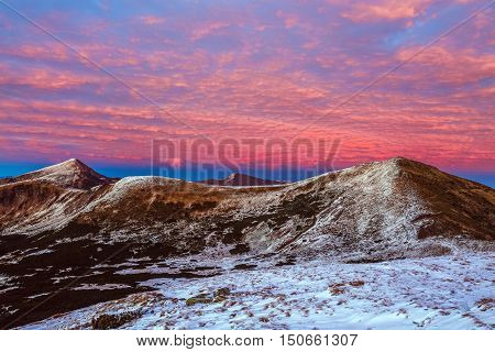 Twilight Mountain View Winter Landscape before Sunrise Forest and Snow on Hills and Summit red color clouds on Sky