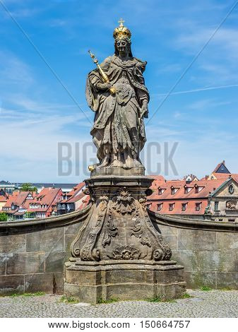 Statue of Saint Cunigunde of Luxembourg as Holy Roman Empress stands over the Regnitz river in Bamberg Bavaria Germany. Built 1750 from Johann Peter Benkert.