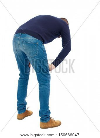 Back view of a man who rests in his hands leaning. Standing young guy. Rear view people collection.  backside view of person.  Isolated over white background.  Man in warm jacket bent wearily.