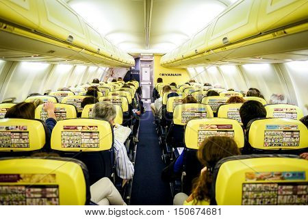 Trieste Italy - May 23 2016: People are sitting on Ryanair flight from Trieste - Italy to Valencia - Spain. The inside of low-cost budget airline commercial plane Boeing 737-800.