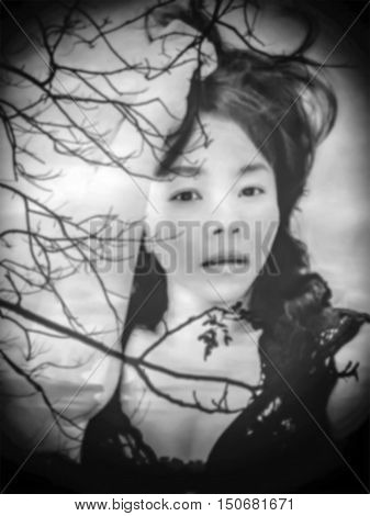 de-focused Beautiful sexy woman in black lace lingerie with double exposure of sunset scene and silhouette of tree black vignette in antique black and white tone