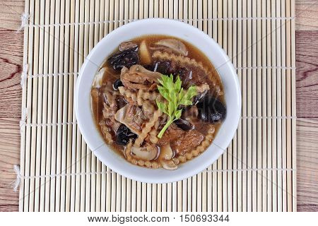Mixed vegetable and tofu sheet in brown soup call 