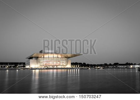 Copenhagen, Denmark - June 05, 2016: The illuminated Opera House designed by Henning Larsen architects in black and white