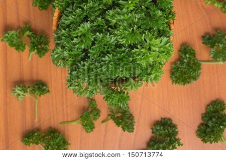 Parsley into a bowl over a wooden table