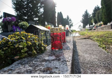 Votive candles lantern on the grave in Slovak cemetery. All Saints' Day. Solemnity of All Saints. All Hallows eve. 1st November. Feast of All Saints. Hallowmas. All Souls' Day