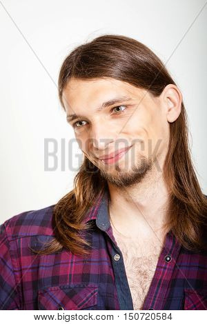 Masculinity concept. Smiling guy with long hairs. Young man in plaid shirt.