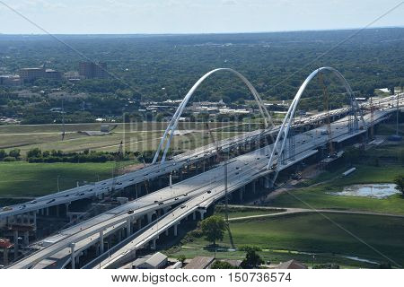 DALLAS, TX - SEP 17: Margaret McDermott Bridge from the Reunion Tower Observation Deck in Dallas, Texas, on Sep 17, 2016. It is a steel suspended arch bridge under construction over the Trinity River.