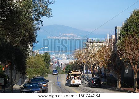 SAN FRANCISCO - DEC 29, 2008: Cablecar in San Francisco, with Alcatraz in the background in San Francisco, California, USA.