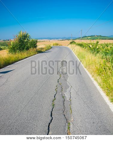 country road has a crack due to the landslide of the earth