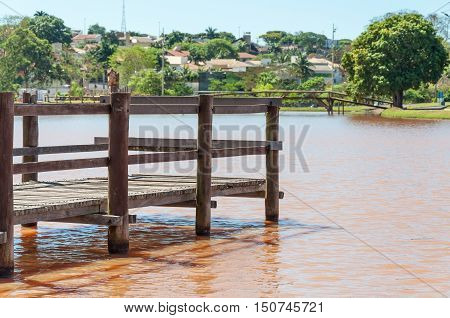 Deck over water lake in a park.