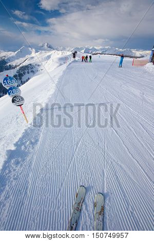 KITZBUEHEL AUSTRIA - February 17 2016 - Skiers skiing in Kitzbuehel ski resort and enjoying Alps view from the top of Hahnenkamm place of famous hahnenkamm races. Kitzbuehel ski resort is one of the best ski resort in the world with 54 cable cars and 170