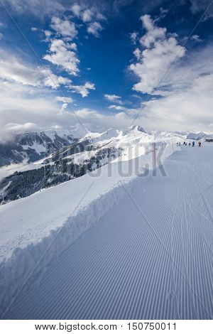 Skiers Skiing In Kitzbuehel Ski Resort And Enjoying Alps View From The Top Of Hahnenkamm, Place Of F