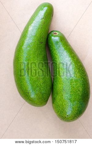 Pair of raw avocados lay on gray background. Yin yang harmony concept