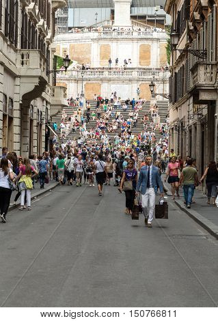 ROME ITALY - JUNE 15 2015: Spanish Steps and Via Condotti in Rome. This street is the center of fashion shopping in Rome with the atelier of Bulgari Armani Cartier Fendi Gucci  and others.