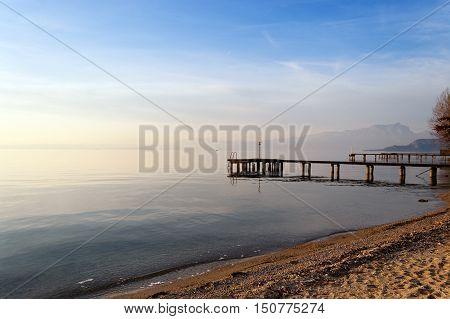 Lago di Garda at twilight in winter (Garda Lake) the largest Italian lake of glacial origin. Lazise Veneto Italy