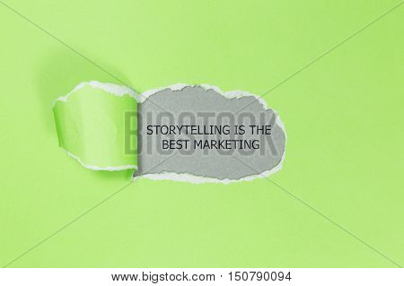 The motivational quote Storytelling is the best Marketing appearing behind torn paper.