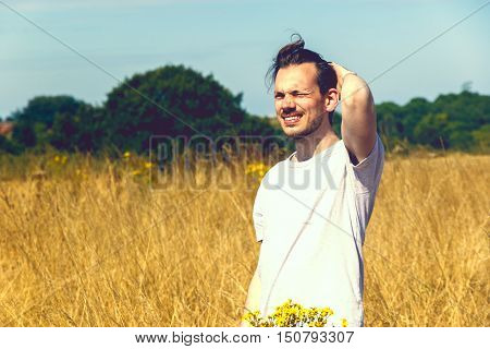Man Standing In Field Of Dry Grass