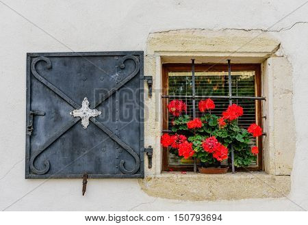 Beautiful old window with flowers, Skofja Loka, Gorenjska, Slovenia.