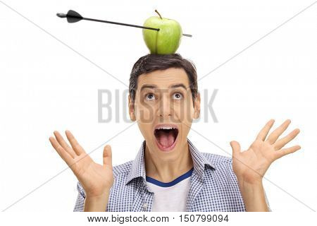 Scared guy looking at an apple pierced by an arrow on his head isolated on white background