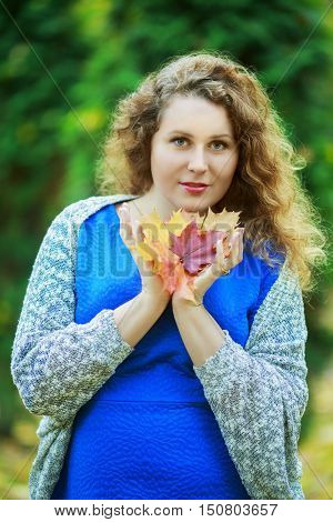 young beautiful plussize model in the autumn park