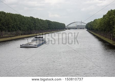 Big barge navigating at Dutch canal near Amsterdam