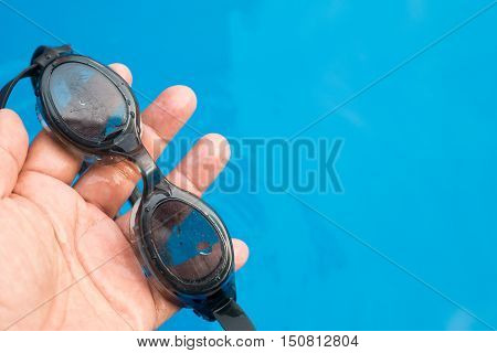 Old Swimming Goggles Has More Scratch On Glass In Hand.