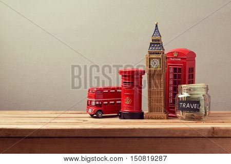 Travel to Great Britain concept with souvenirs and money box jar. Planning summer vacation money budget trip concept.