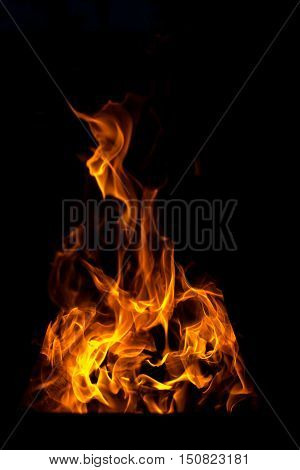 Fire flames bonfire at night on black background