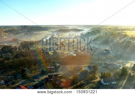 misty morning with houses and tree which are photographed from helicopter
