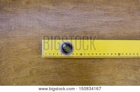 Pieces of wood flooring with a carpenters spirit level