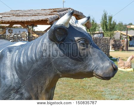 Black And White Toy Cow With A Bell